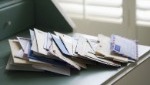 Stack of mail in envelopes on desk